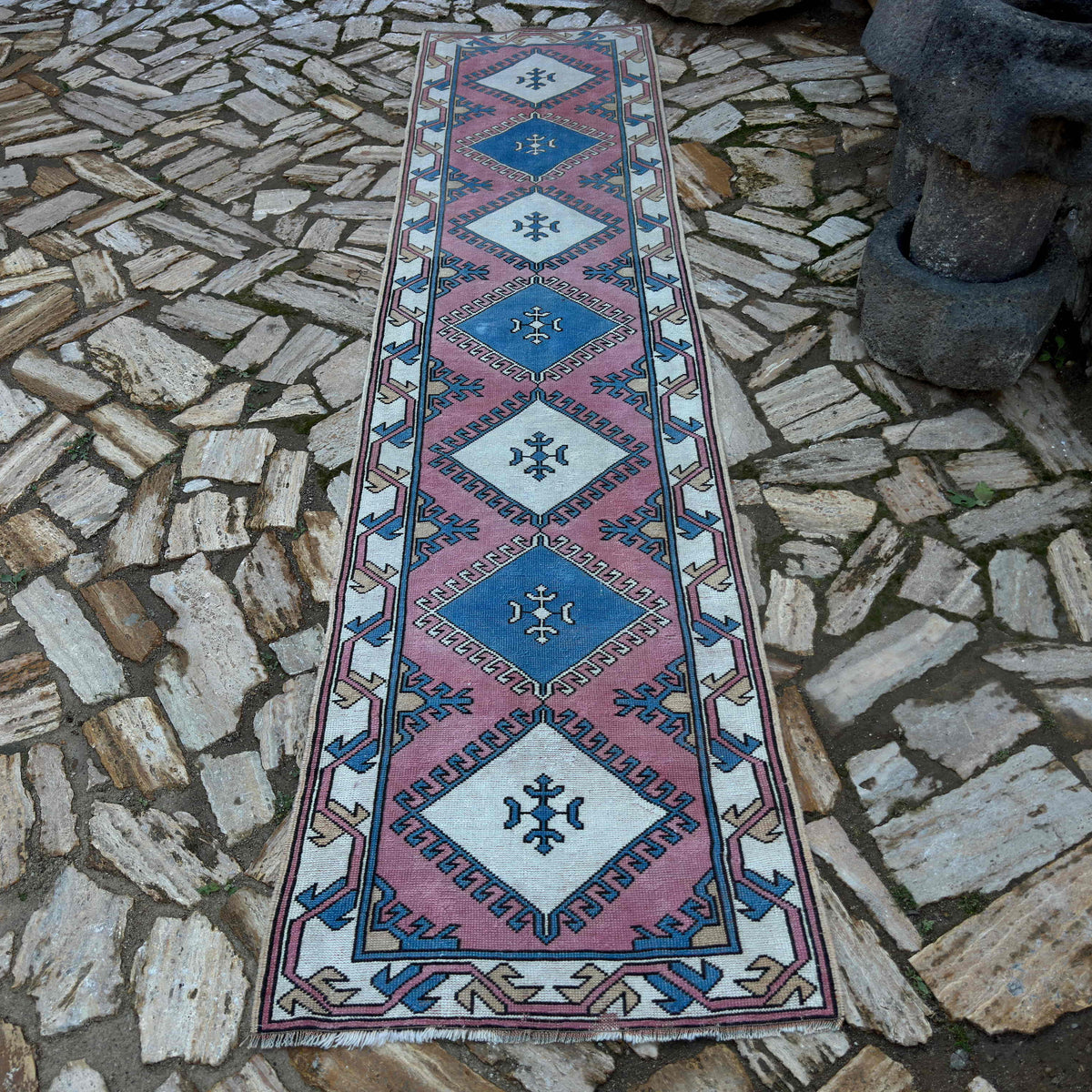 Pink 3' x 11' Turkish runner rug in wool and cotton, shown on the floor.