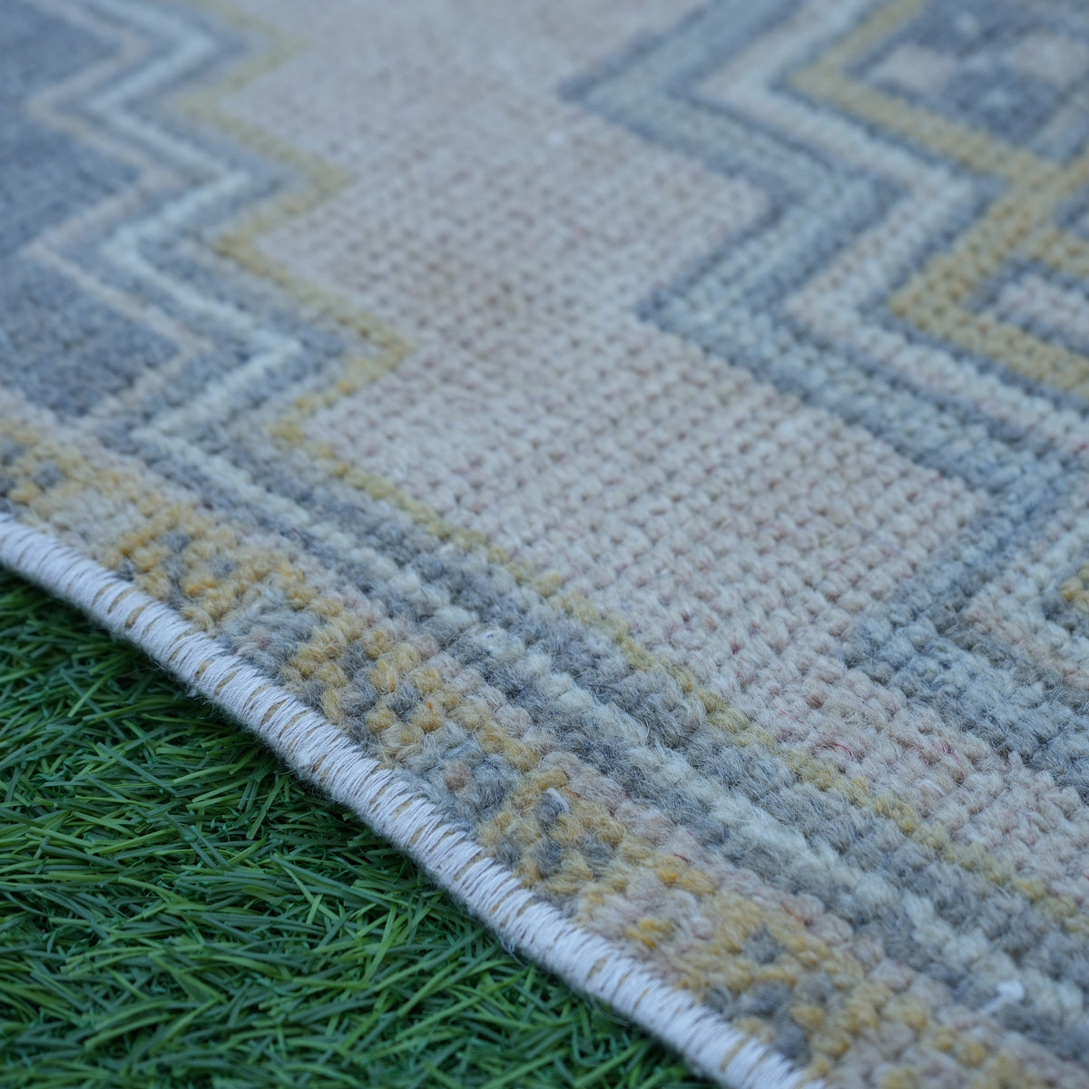 Pink 2' x 4' Turkish small anatolian rug in wool and cotton, shown on the floor.