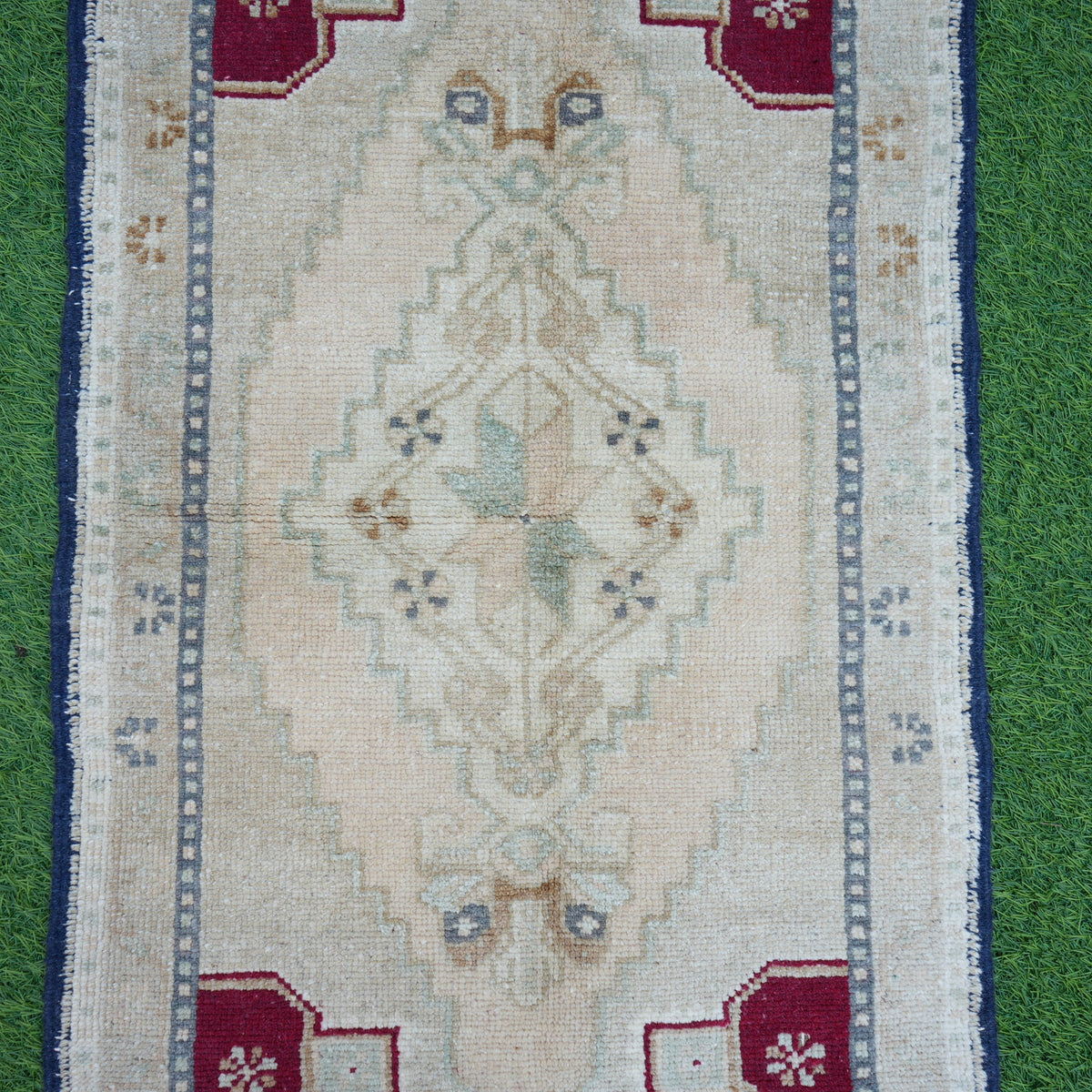 Beige 2' x 3' small turkish rug in wool and cotton, shown on the floor.