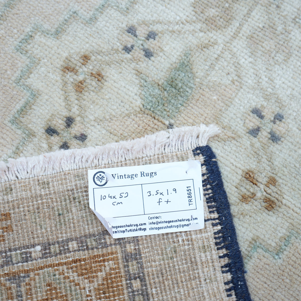 Beige 2' x 3' small turkish rug from the 1970s with traditional design.