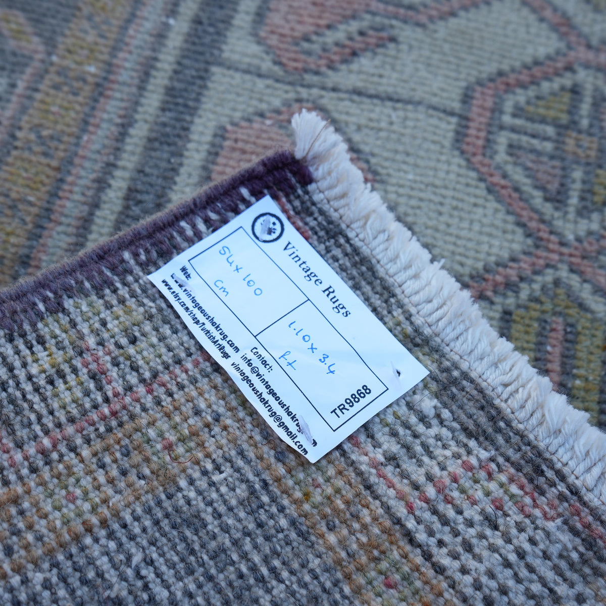 Black 2' x 3' small turkish rug from the 1970s with traditional design.