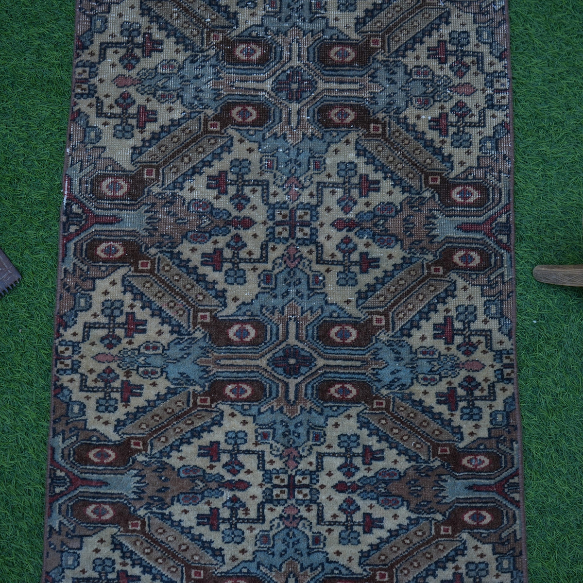 Close-up of the brown small turkish rug showing traditional details, hand-knotted weave, wool and cotton and low pile.