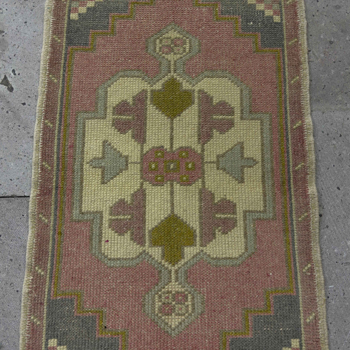 1970s pink small turkish rug with traditional design, hand-knotted weave and low pile.