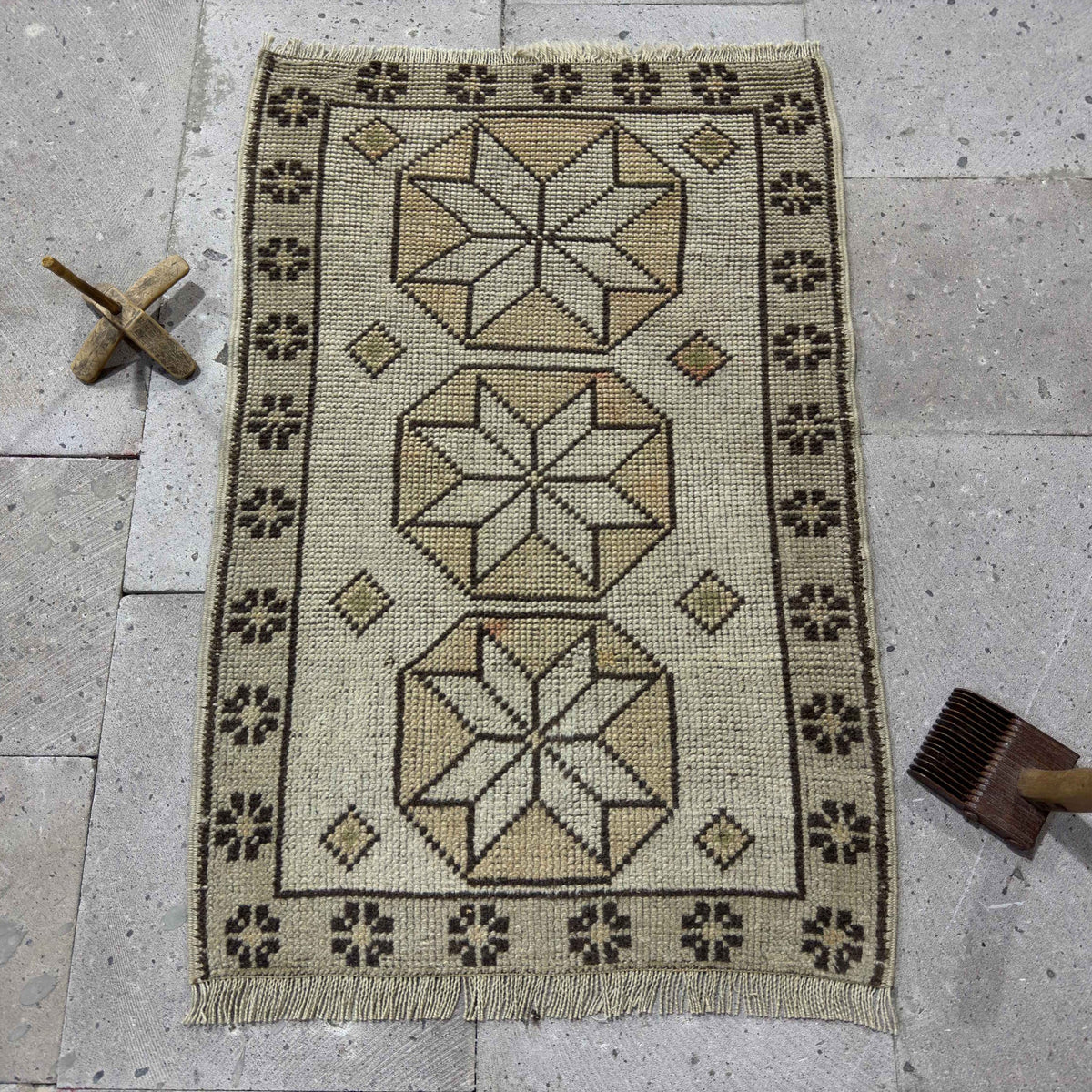 Beige 2' x 3' Turkish small vintage geometric rug in wool and cotton, shown on the floor.