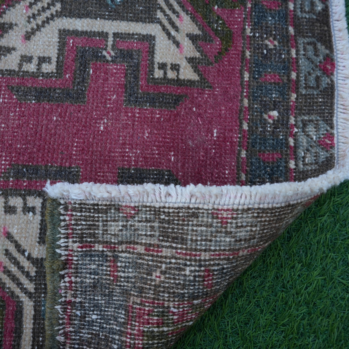 1970s red Turkish small vintage rug with traditional design, hand-knotted weave and low pile.
