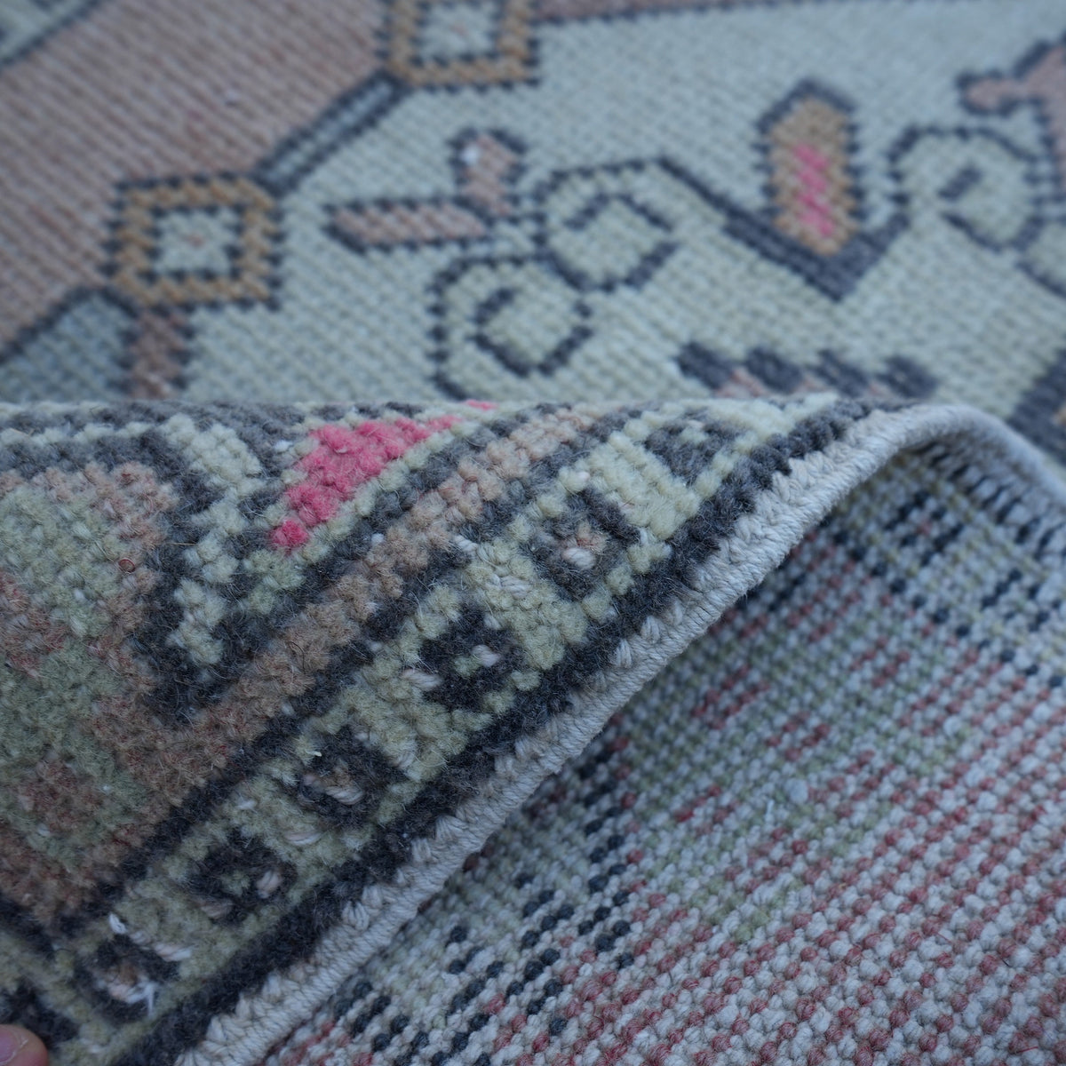 Additional view of the red Turkish small vintage rug, hand-knotted in wool and cotton.
