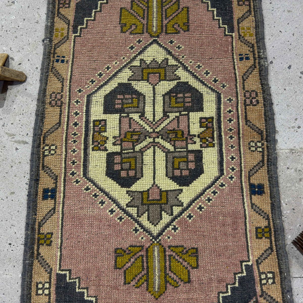 1970s pink Turkish small vintage rug with traditional design, hand-knotted weave and low pile.
