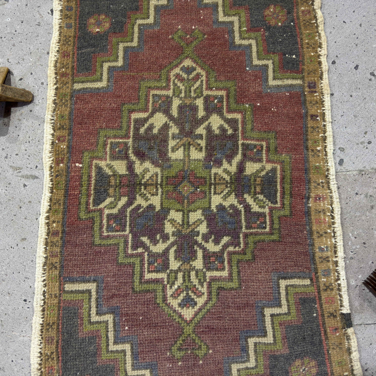 1970s red Turkish small vintage rug with traditional design, hand-knotted weave and low pile.