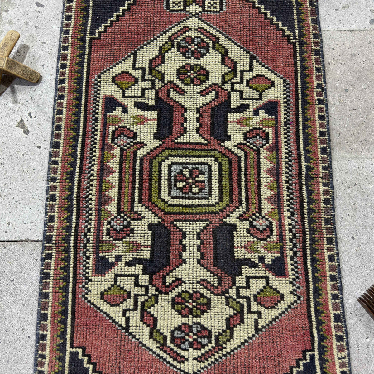 1970s red Turkish small vintage rug with traditional design, hand-knotted weave and low pile.