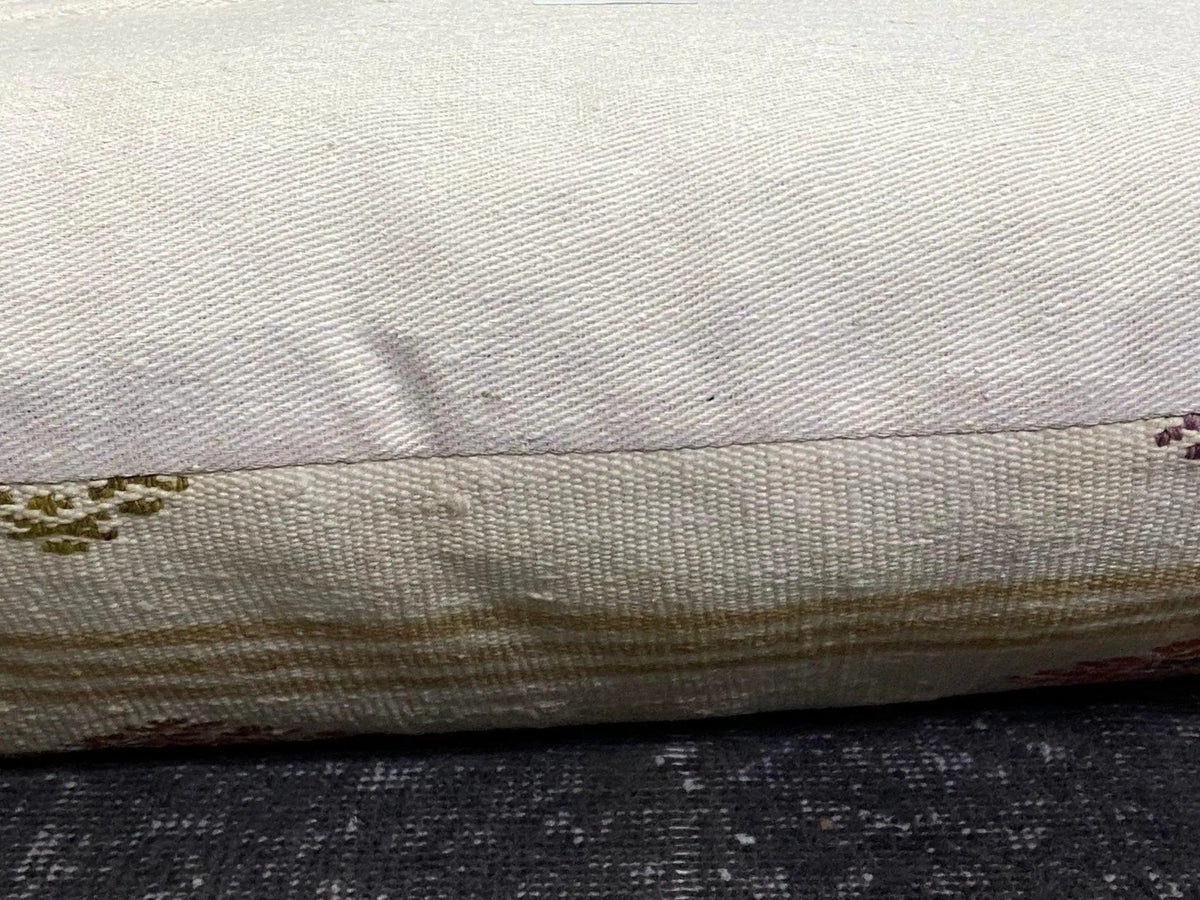 Beige Turkish throw pillow, shown on the floor.