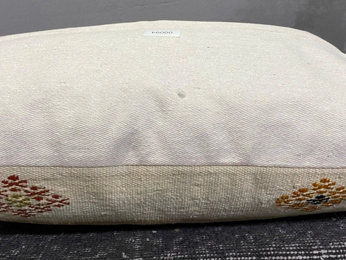 Beige Turkish throw pillow, shown on the floor.