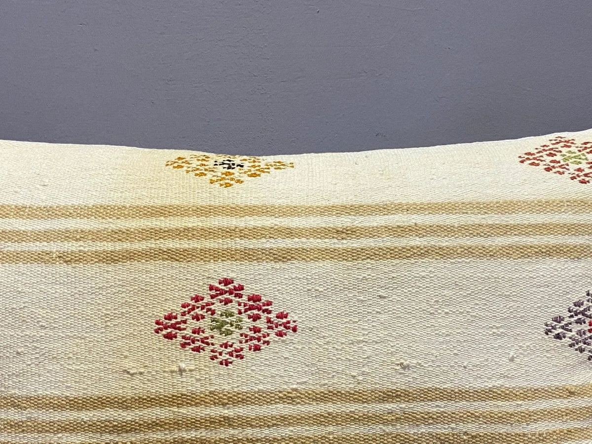 Close-up of the beige Turkish throw pillow showing traditional details, low pile.