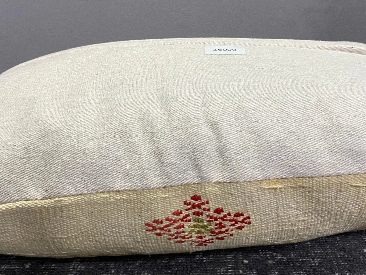 Beige Turkish throw pillow, shown on the floor.