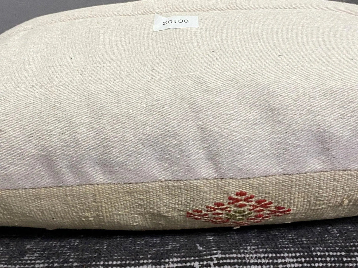 Beige Turkish throw pillow, shown on the floor.