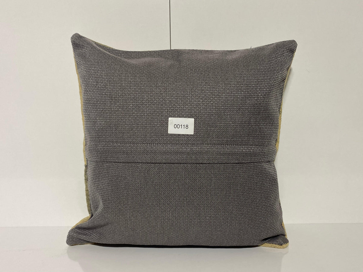 Close-up of the beige Turkish throw pillow showing striped details, low pile.