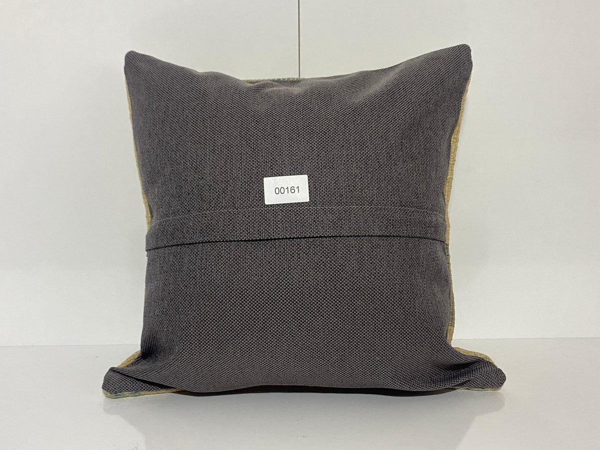 Close-up of the beige Turkish throw pillow showing striped details, low pile.