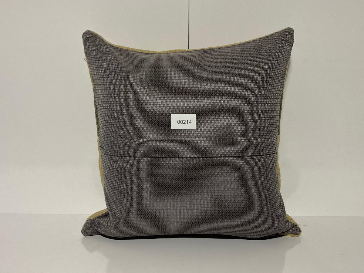 Close-up of the beige Turkish throw pillow showing striped details, low pile.