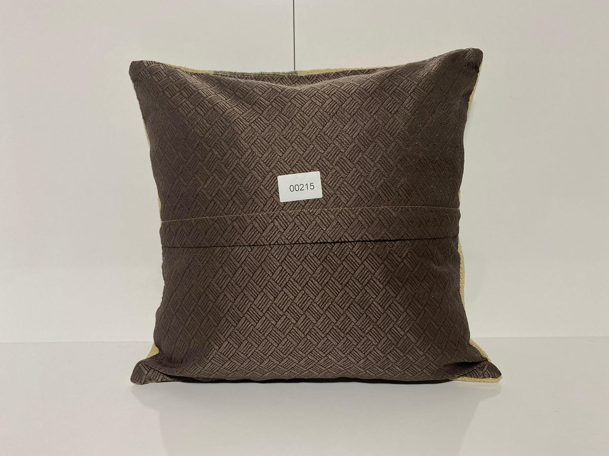Close-up of the beige Turkish throw pillow showing striped details, low pile.