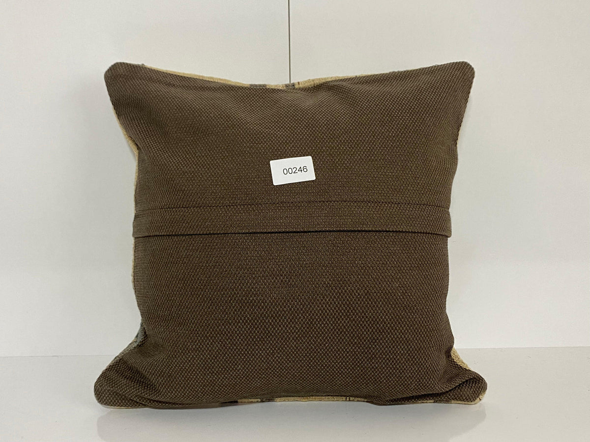Close-up of the beige Turkish throw pillow showing striped details, low pile.