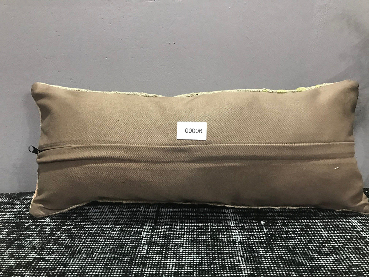 Beige Turkish throw pillow, shown on the floor.