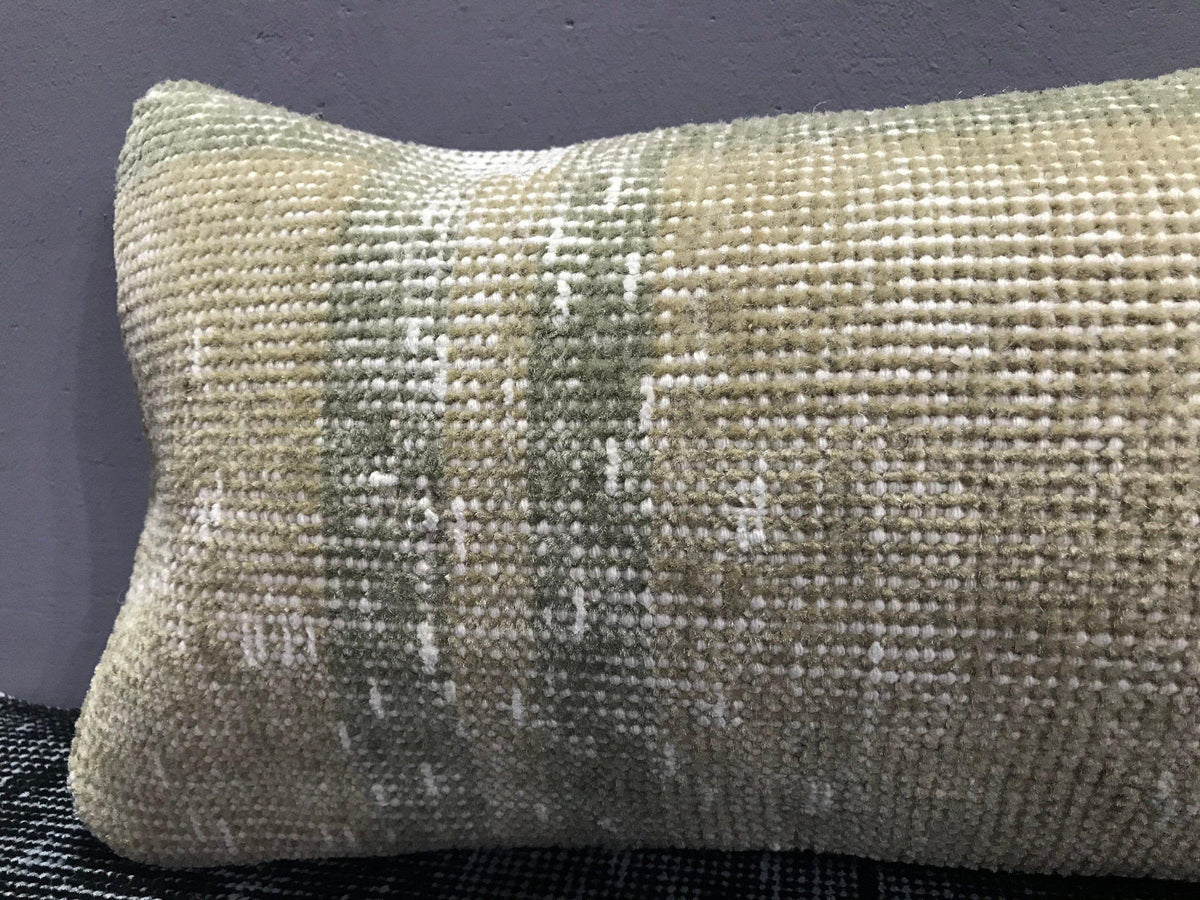 Close-up of the beige Turkish throw pillow showing neutral details, low pile.