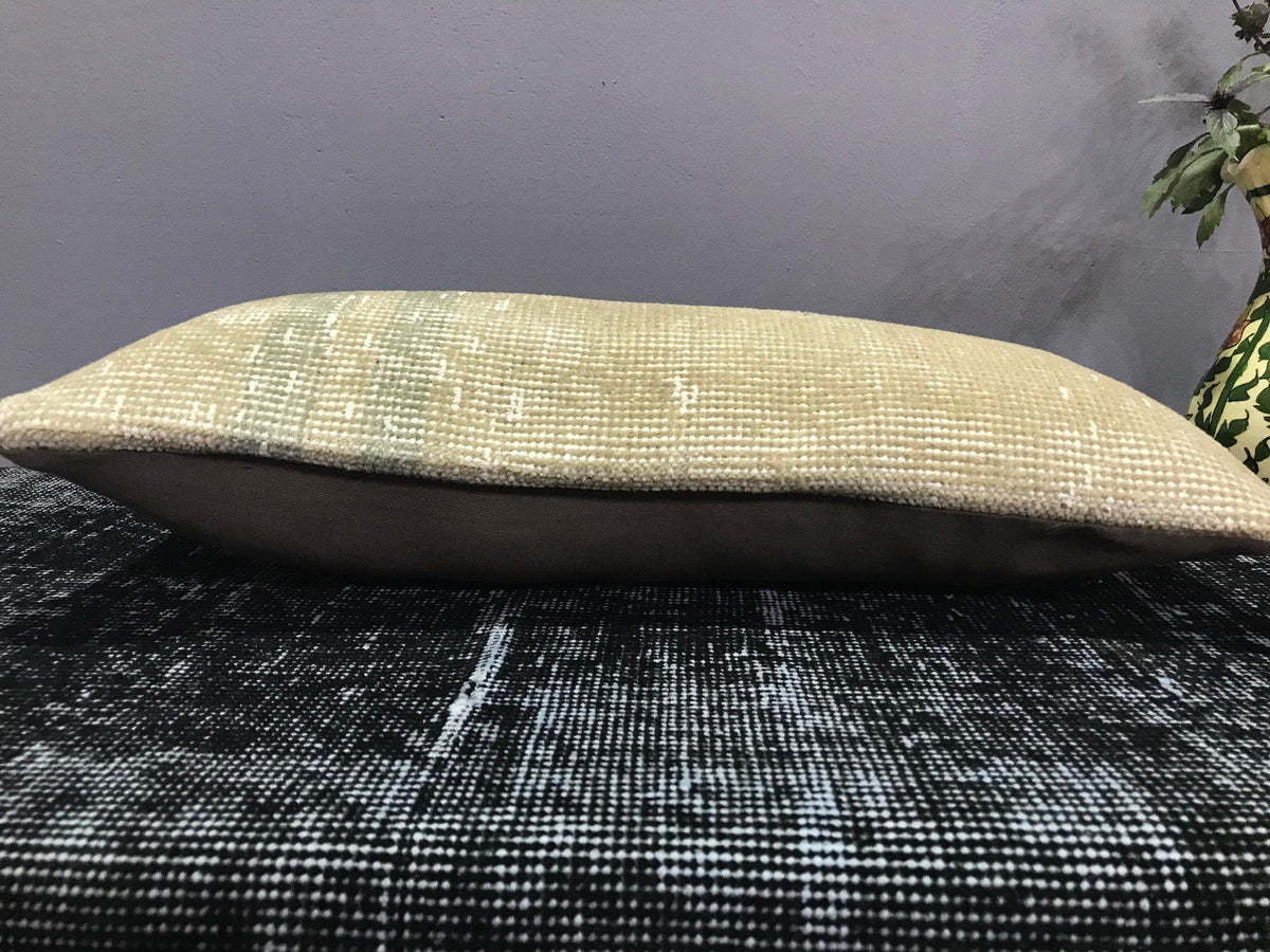 Beige Turkish throw pillow, shown on the floor.