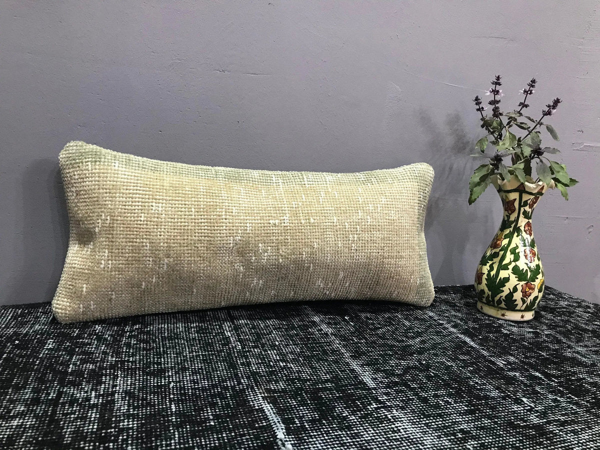 Beige Turkish throw pillow, shown on the floor.