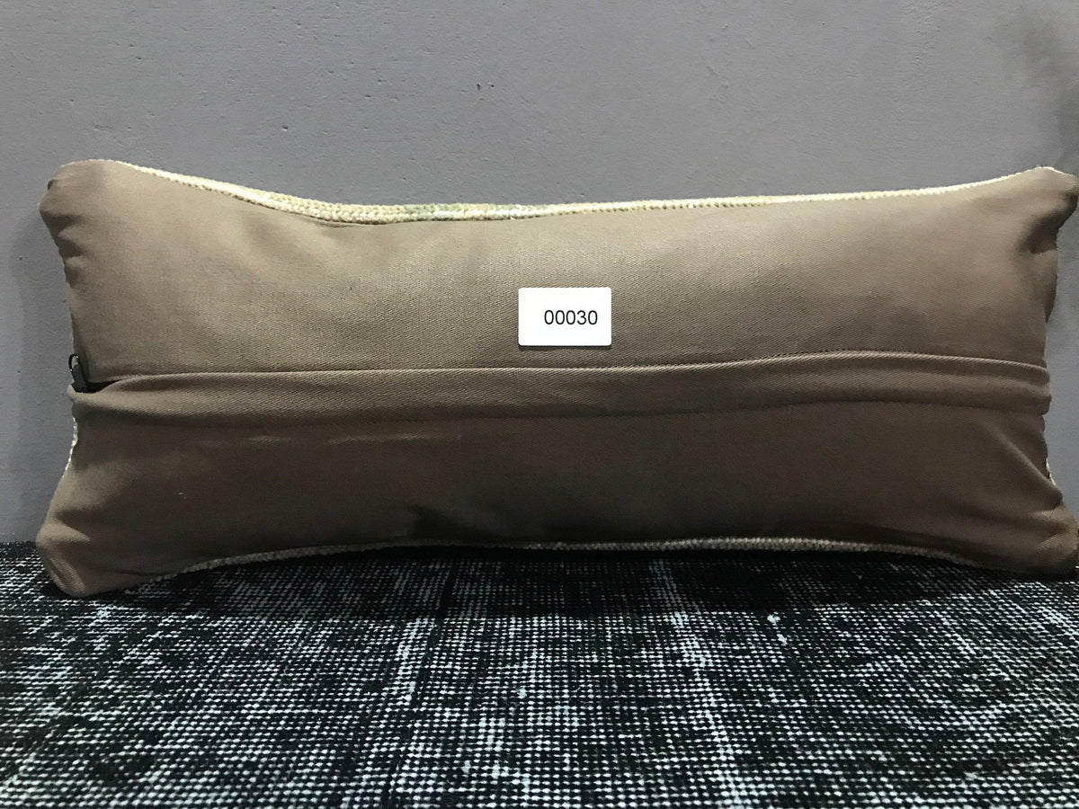 Beige Turkish throw pillow, shown on the floor.