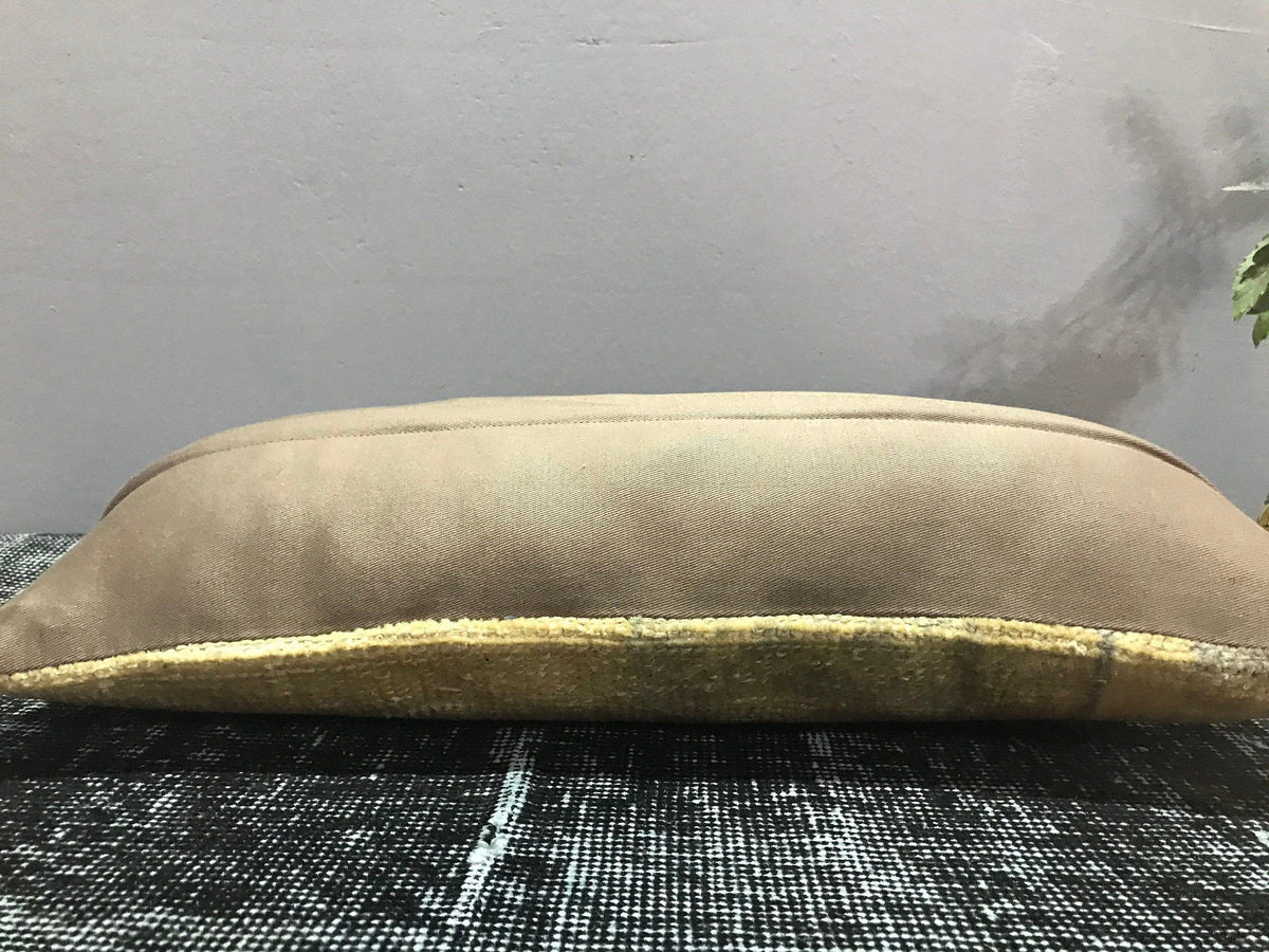 Beige Turkish throw pillow, shown on the floor.