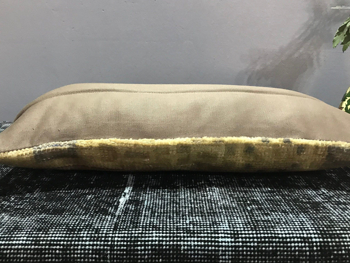 Beige Turkish throw pillow, shown on the floor.