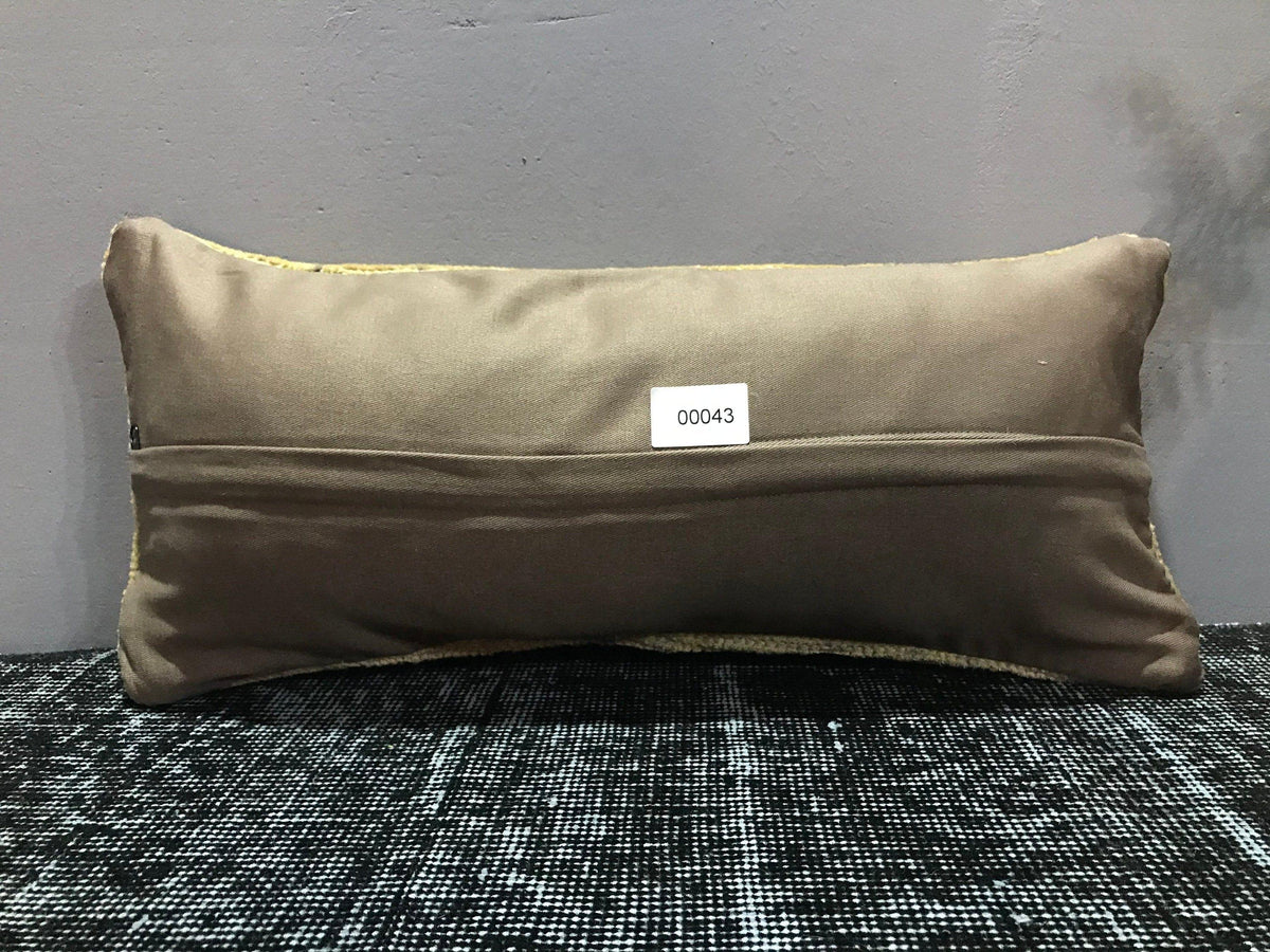 Beige Turkish throw pillow, shown on the floor.