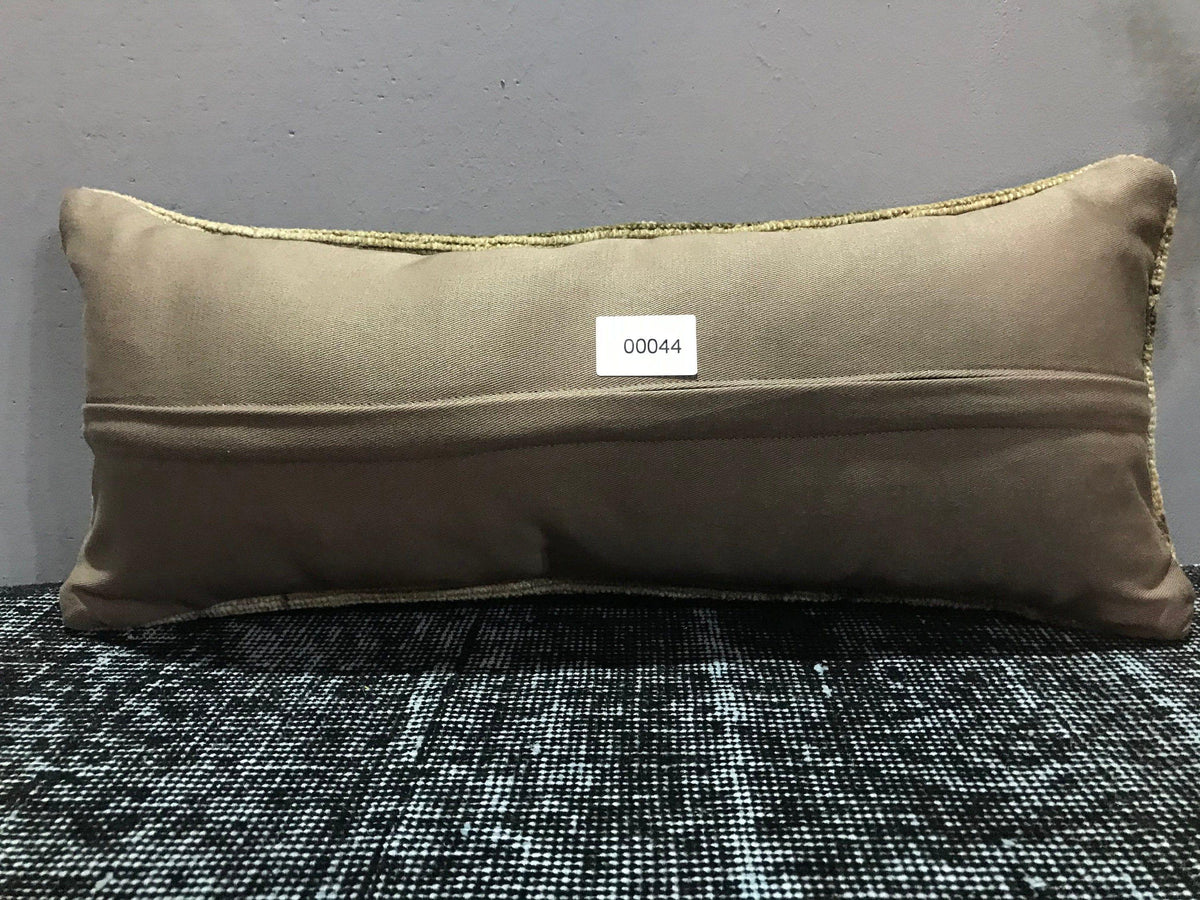 Beige Turkish throw pillow, shown on the floor.