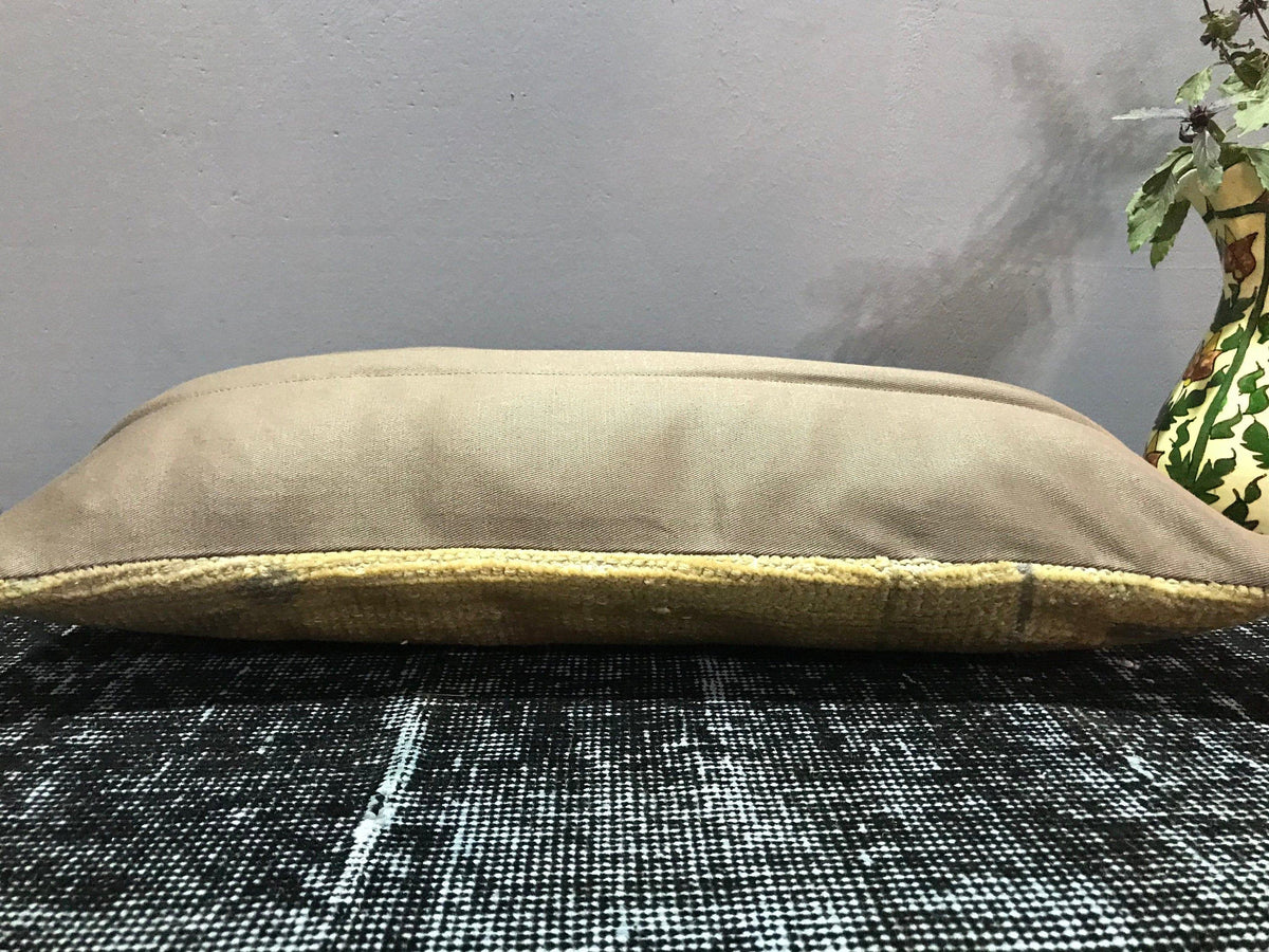 Beige Turkish throw pillow, shown on the floor.