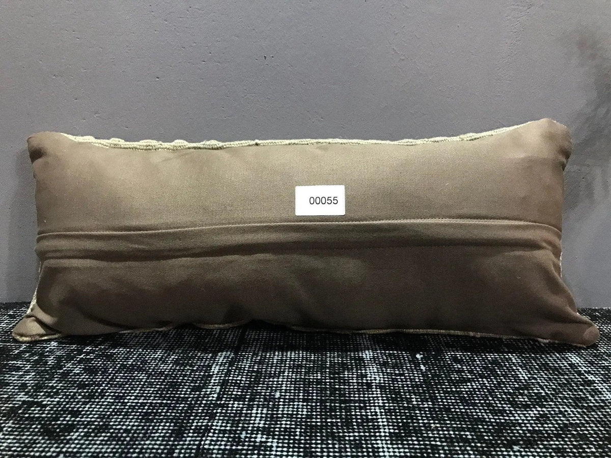 Beige Turkish throw pillow, shown on the floor.