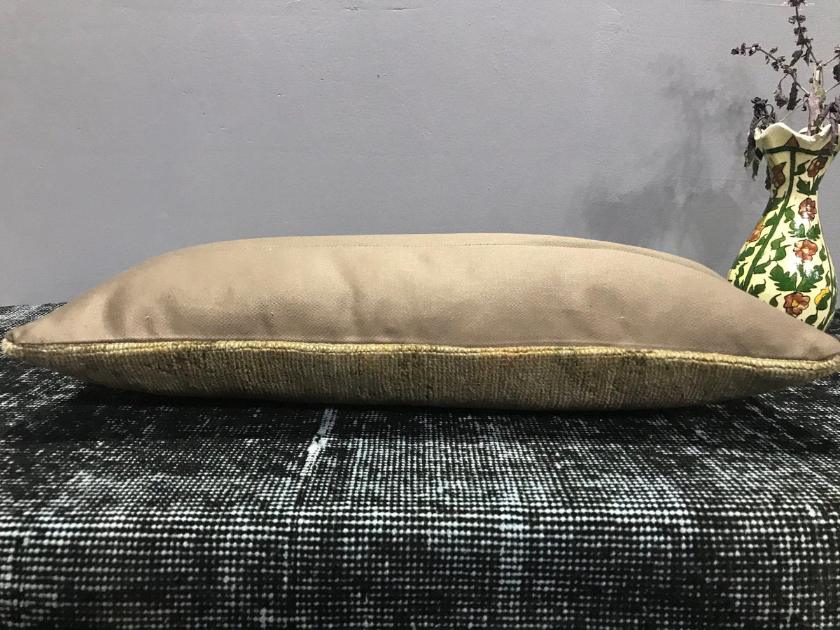 Beige Turkish throw pillow, shown on the floor.