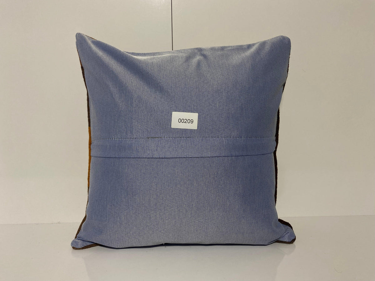Close-up of the brown Turkish throw pillow showing geometric details, low pile.
