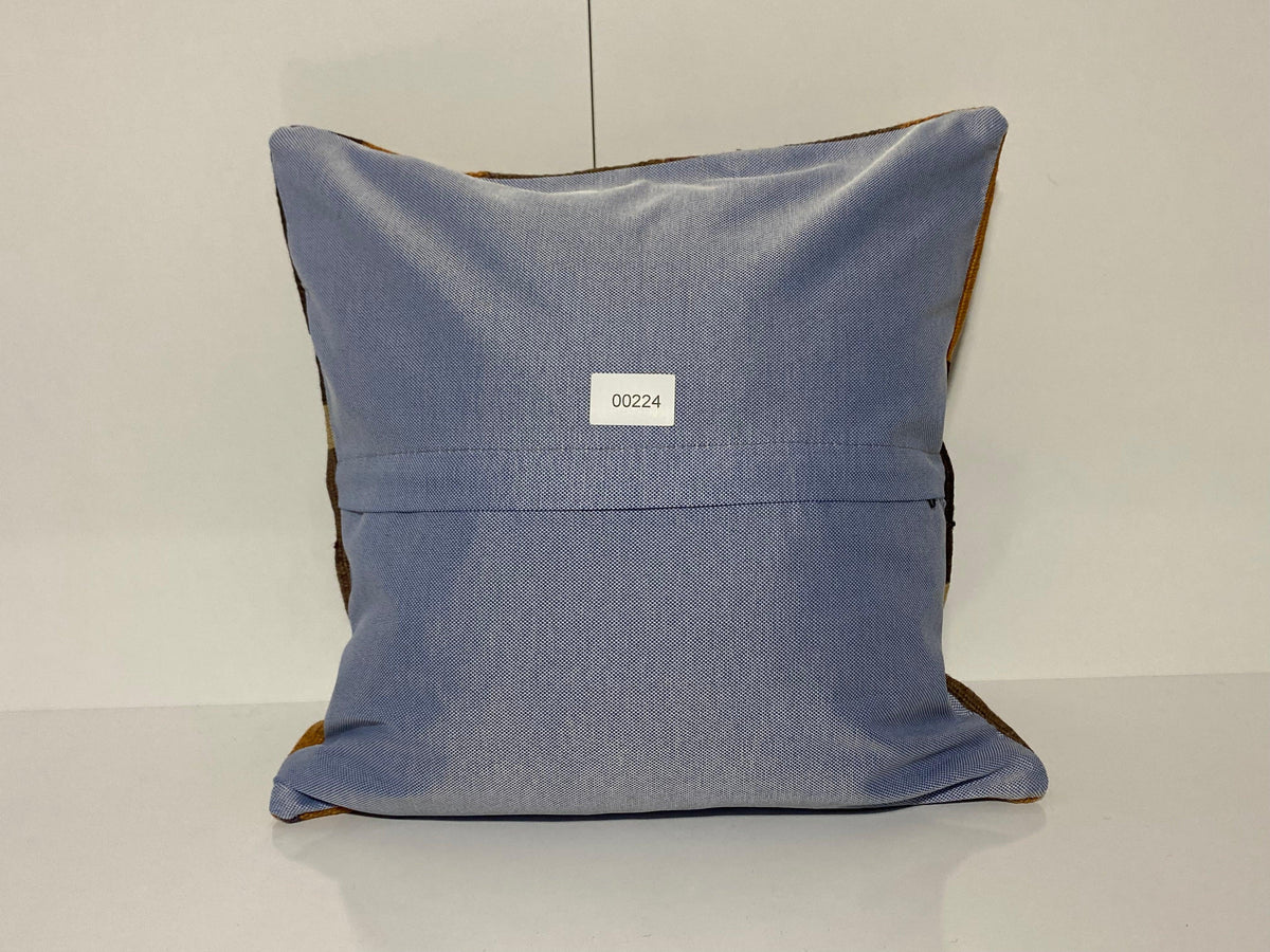 Close-up of the brown Turkish throw pillow showing geometric details, low pile.