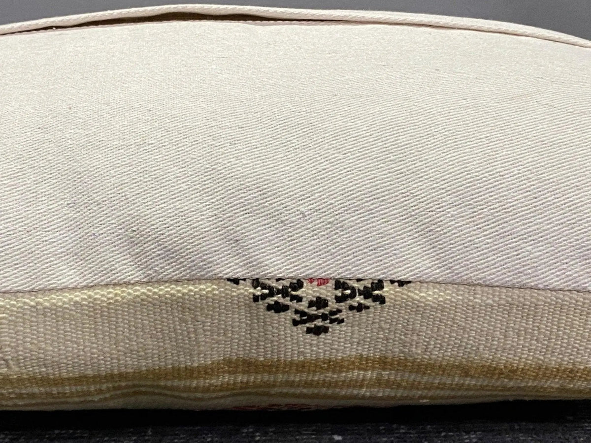Close-up of the colorful Turkish throw pillow showing striped details, low pile.