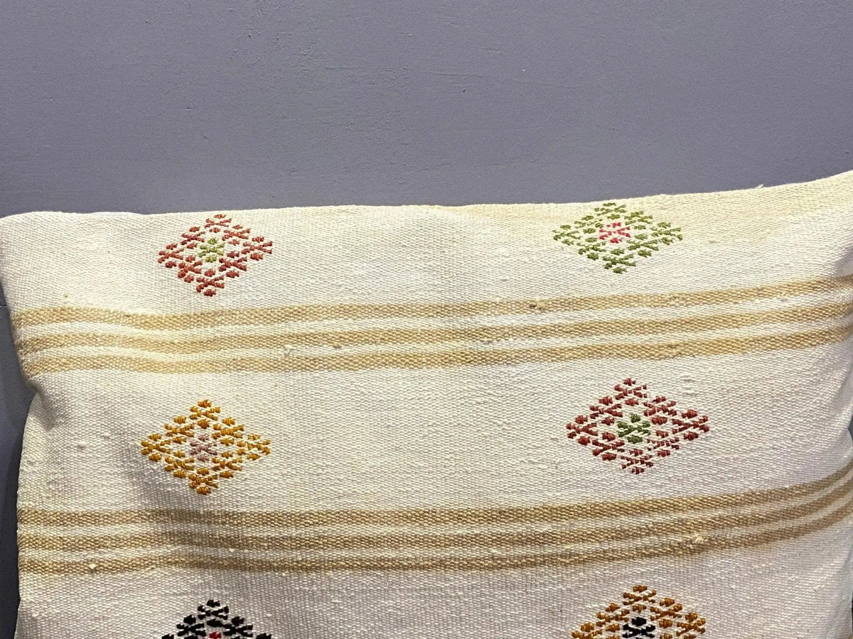 Close-up of the colorful Turkish throw pillow showing striped details, low pile.