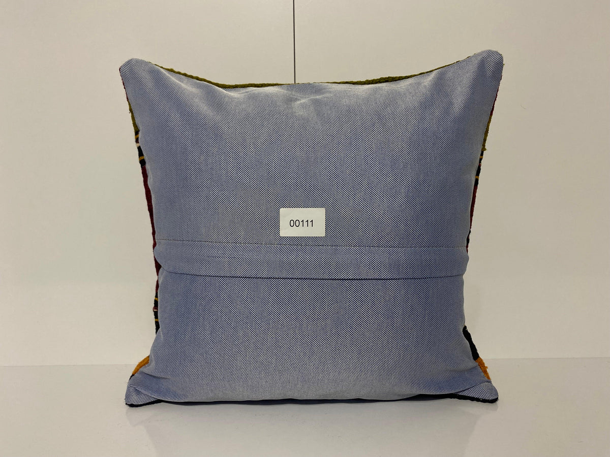 Close-up of the colorful Turkish throw pillow showing striped details, low pile.