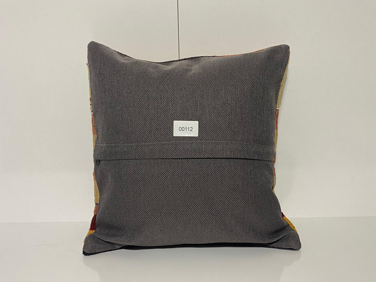 Close-up of the colorful Turkish throw pillow showing striped details, low pile.