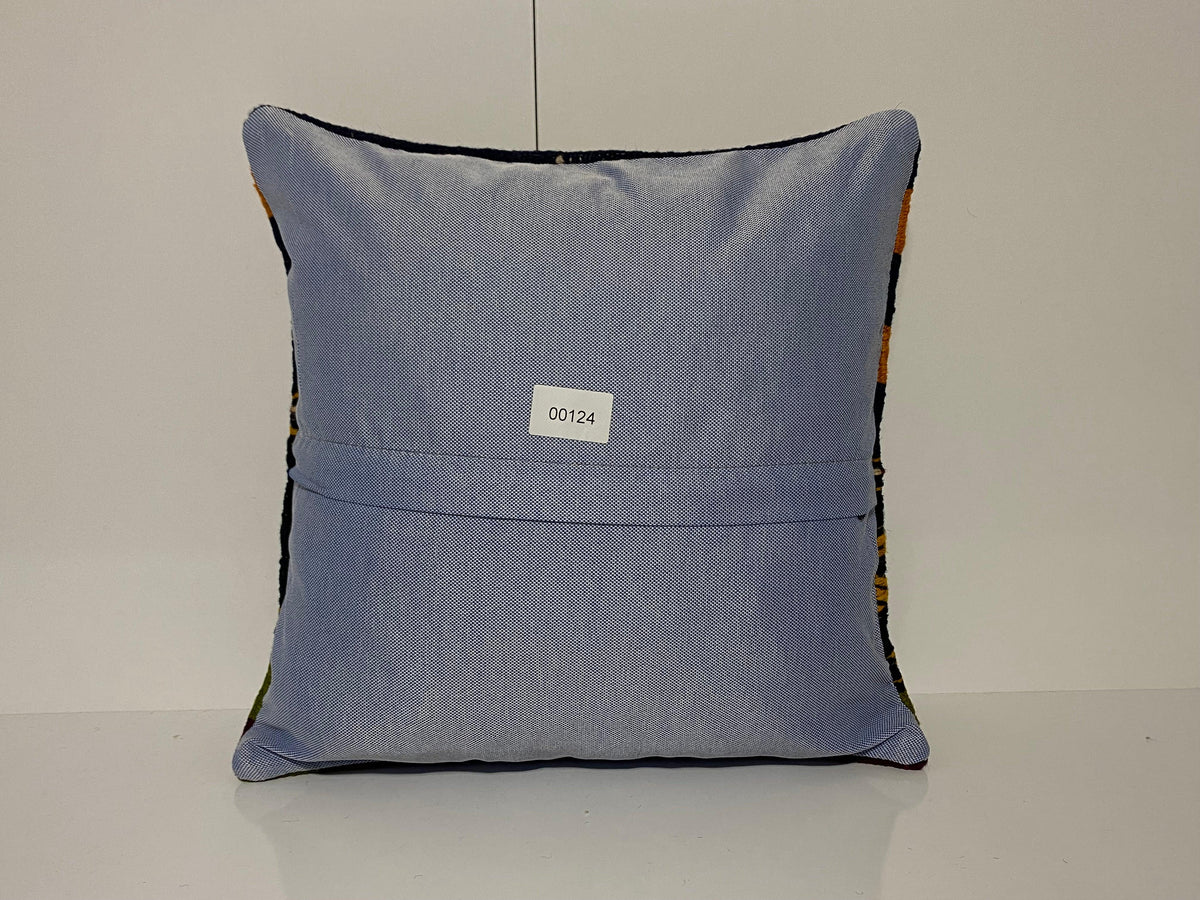Close-up of the colorful Turkish throw pillow showing striped details, low pile.