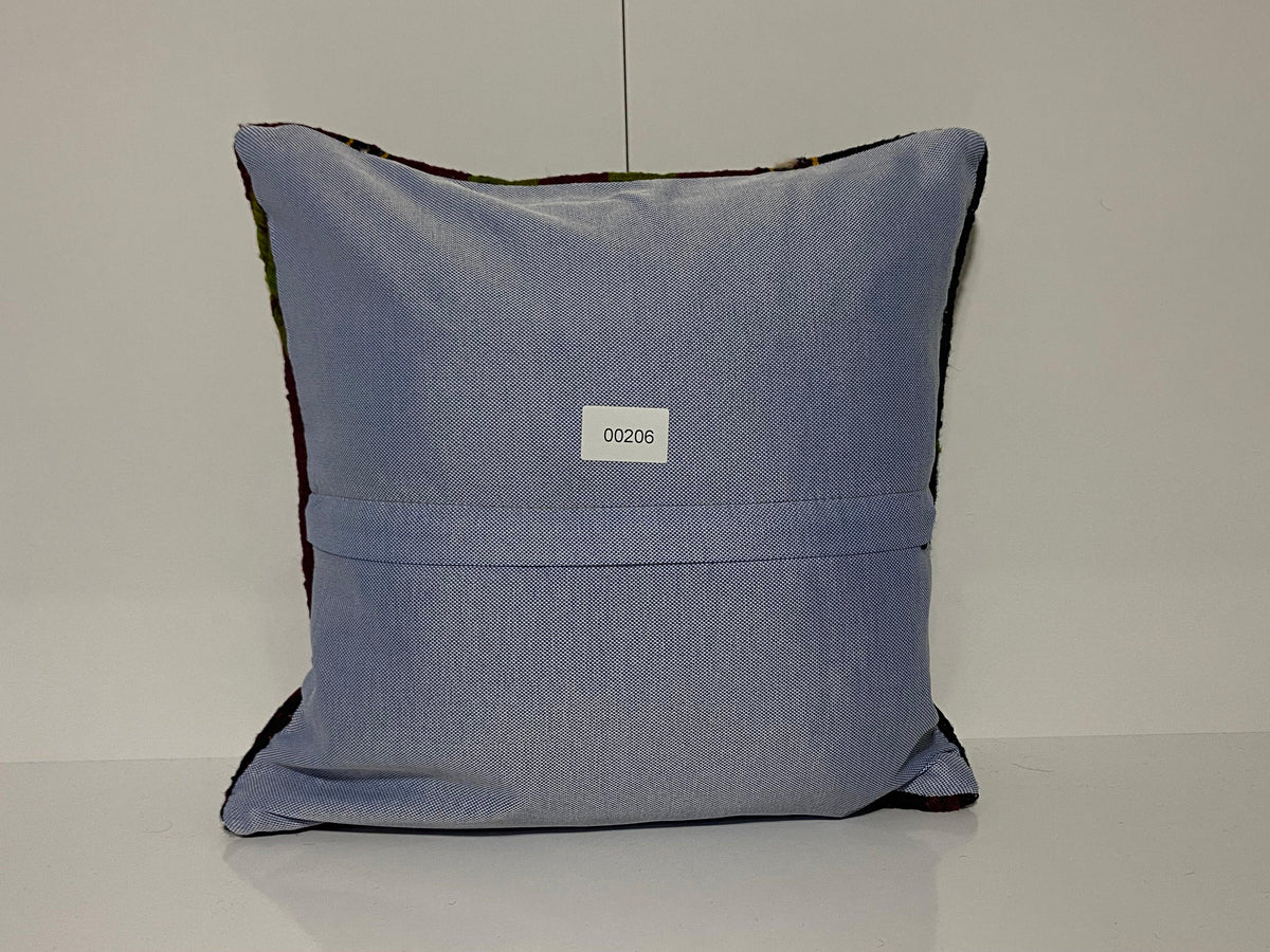 Close-up of the colorful Turkish throw pillow showing striped details, low pile.