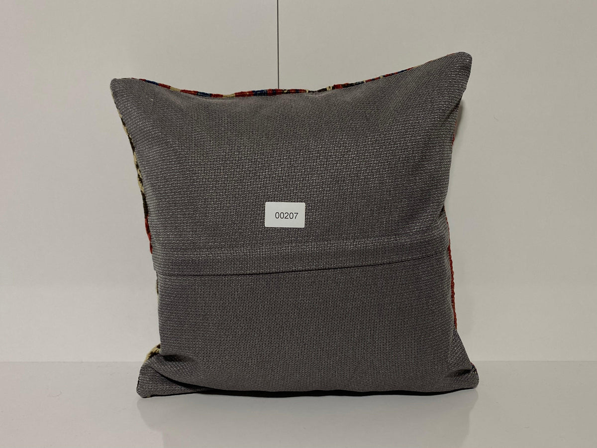 Close-up of the colorful Turkish throw pillow showing striped details, low pile.