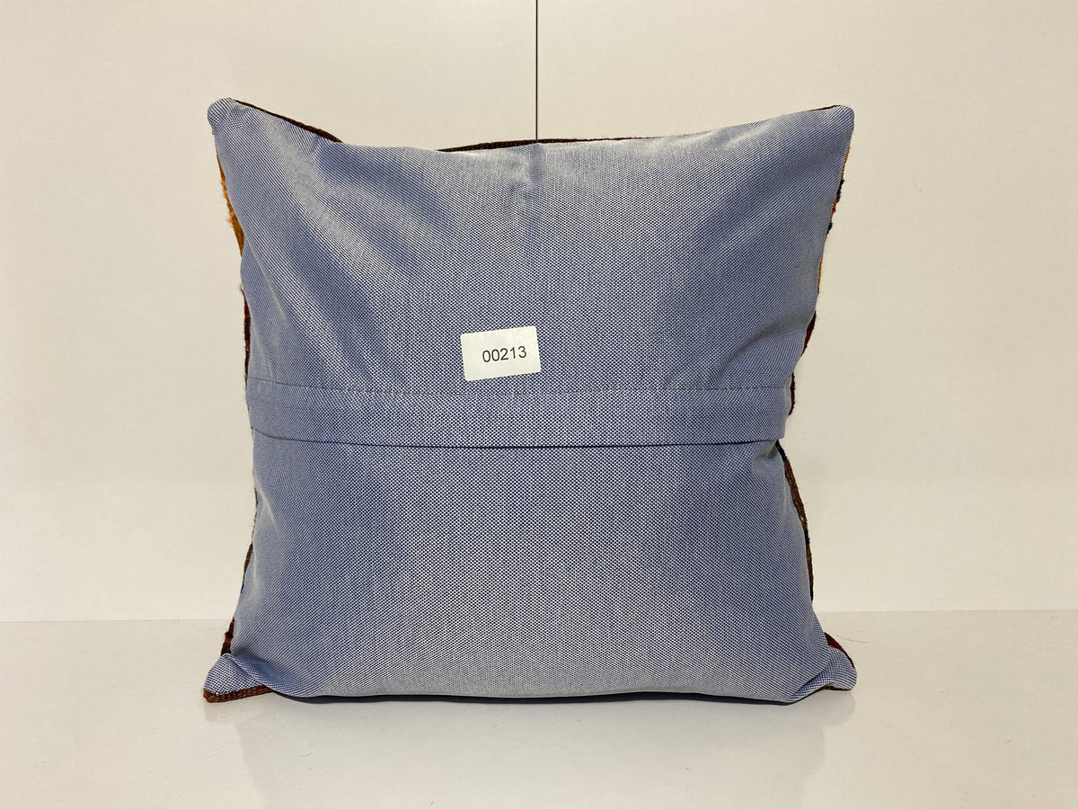 Close-up of the colorful Turkish throw pillow showing striped details, low pile.