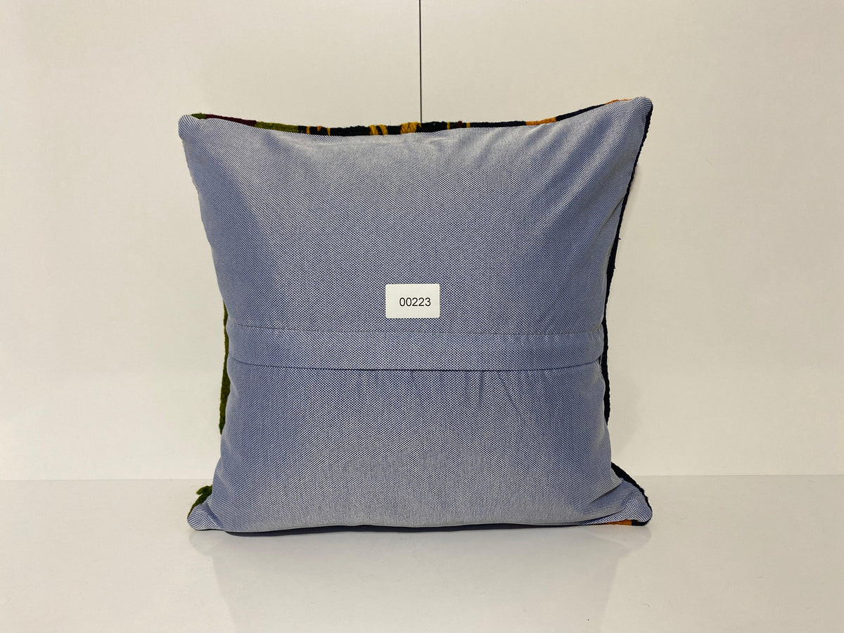 Close-up of the colorful Turkish throw pillow showing striped details, low pile.