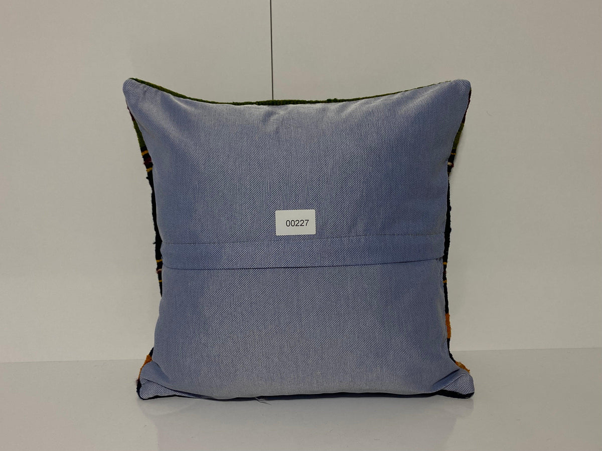 Close-up of the colorful Turkish throw pillow showing striped details, low pile.