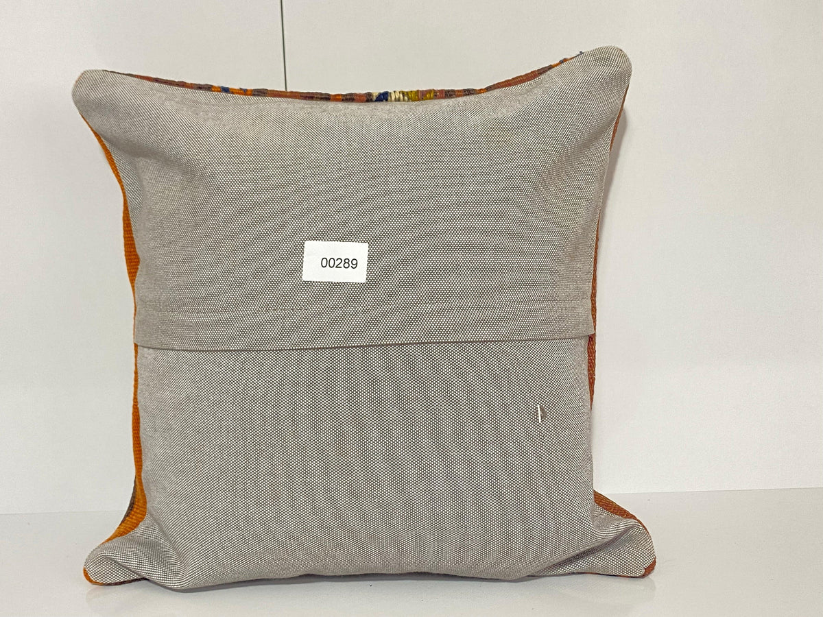 Close-up of the colorful Turkish throw pillow showing striped details, low pile.