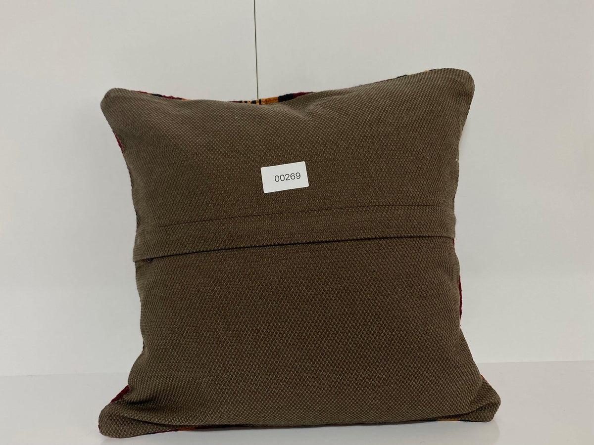 Close-up of the red Turkish throw pillow showing striped details, low pile.
