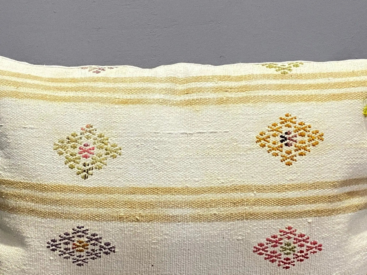 Close-up of the white Turkish throw pillow showing traditional details, low pile.